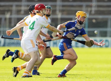 Antrim's Kevin McKiernan and Conor McCann with Colm Gavin of Clare