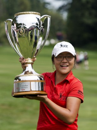Lydia Ko, of New Zealand holds up the trophy after winning the LPGA Tour's Canadian Women's Open
