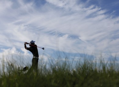 Ryo Ishikawa of Japan watches his tee shot on the 11th hole during the first round.