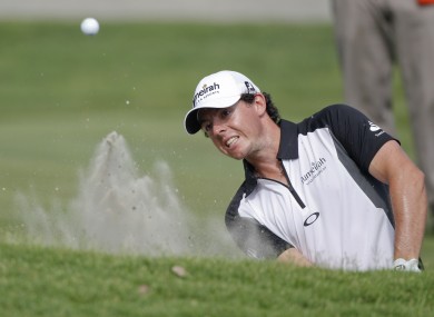 Rory McIlroy chips onto the ninth green.