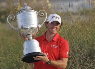 Rory McIlroy of Northern Ireland poses for photographers with the championship trophy after the final round of the PGA Championship golf tournament.