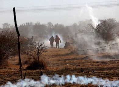 Striking Lonmin mineworkers amidst tear gas as police opened fire.