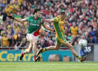 Colm McFadden of Donegal holds off Ger Cafferkey of Mayo.