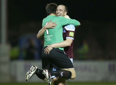 Drogheda United's Gabriel Sava hugs Alan Byrne after teammate John Sullivan's late winning goal.