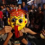 A masked artist prepares to perform a traditional dance on the first day of the week-long Indra Jatra festival in Katmandu, Nepal. (AP Photo/Niranjan Shrestha)