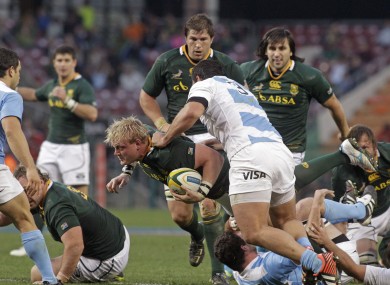 Adriaan Strauss, center, runs into Juan Figallo.