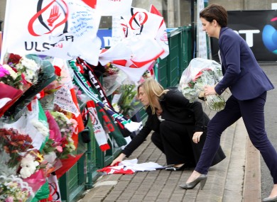 Tributes are left at Ravenhill rugby ground, Belfast, where a book of condolence was opened in memory of Nevin Spence who died in Saturday's tragedy.