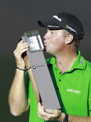 Peter Hanson from Sweden kisses his champion trophy during the award ceremony of the Masters golf tournament in Shanghai.