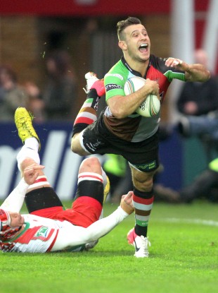 Harlequins' Danny Care dives over ahead of Biarritz's Wenceslas Lauret to score the first try.