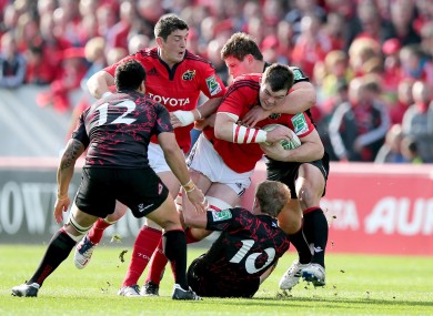 Peter O'Mahony of Munster is tackled by Ross Ford of Edinburgh.
