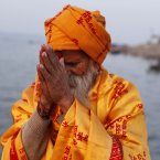 A Sadhu, or a Hindu holy man, offers prayers to the Sun God on Somvati Purnima or a full moon day that falls on a Monday at Sangam in Allahabad, India. Allahabad on the confluence of the rivers Ganges and Yamuna is one of Hinduism's important centres. (AP Photo/Rajesh Kumar Singh)
