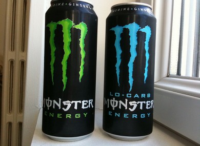 Two cans of Monster energy drink.