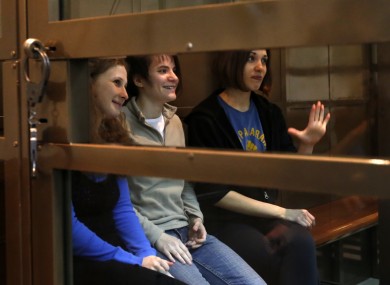 Three members of Pussy Riot in their glass cage during the court case in Moscow.