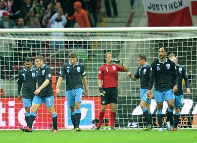 England players stand dejected after Poland's Kamil Glik (not in picture) scores his side's first goal of the game.