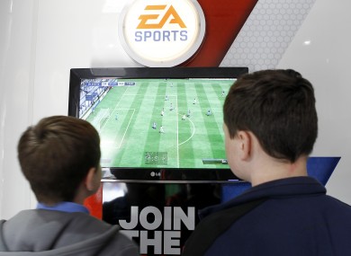 Young Everton fans enjoy a game on FIFA 13.
