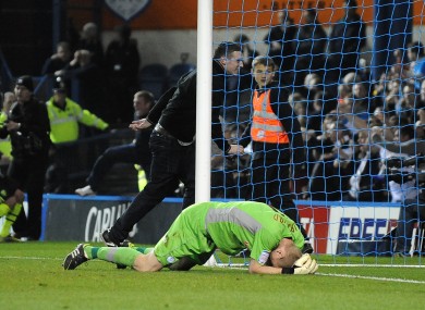 Sheffield Wednesday goalkeeper Chris Kirkland lays on the ground after been struck by a Leeds United fan.