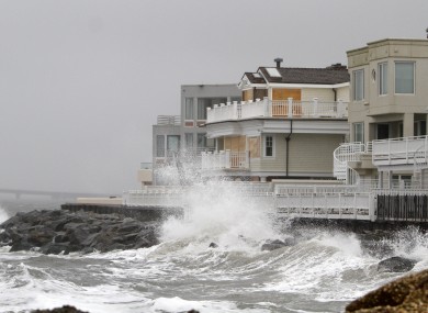 Waves crash onto the sea wall protecting homes in Longport, New Jersey yesterday
