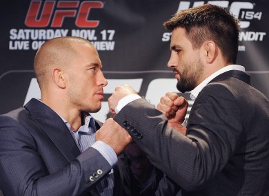 Georges St-Pierre, left, squares off with Carlos Condit.