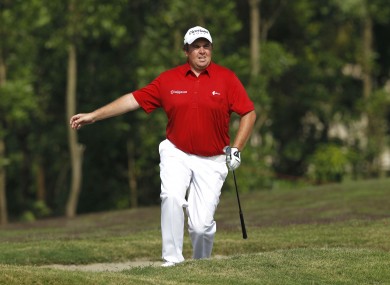Shane Lowry from Ireland runs out of the bunker at the 9th hole this morning.