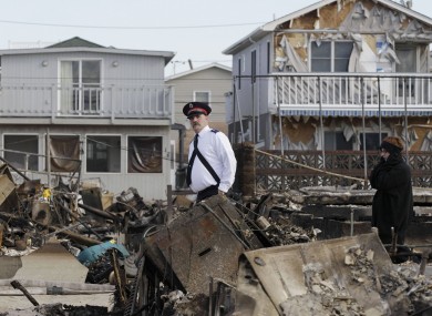 A member of the Salvation Army walks past homes in Breezy Point in New York yesterday