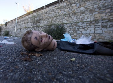 A mannequin's head, bottles and and other debris lie in the Madrid Arena venue car park Madrid after the incident.