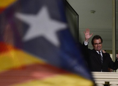 The leader of the centre-right Catalan Nationalist Coalition Artur Mas waves to crowds at a rally in Barcelona last night.