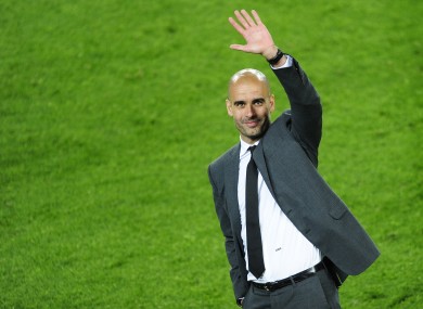 Guardiola waves to Barcelona fans in May.