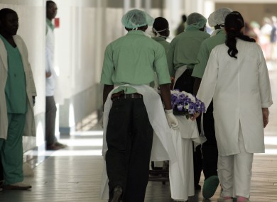 File image of hospital hospital staff pushing trolley's carrying bodies of people trampled to death in a stampede at another event at Luanda stadium.
