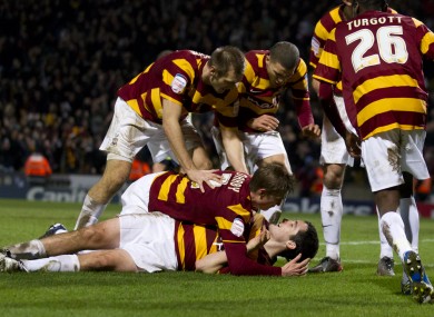 Bradford City's Carl McHugh, bottom, celebrates with jubilant teammates.
