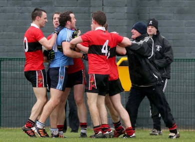 UUJ's Emmett McGuckian gets involved with UCC manager Billy Morgan.