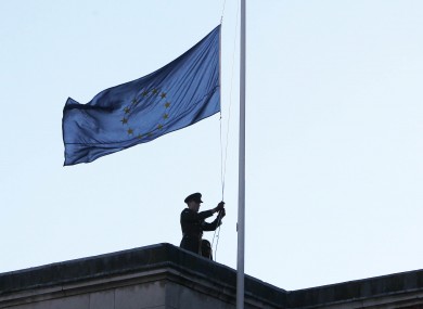 A soldier raises the EU flag over Dublin Castle