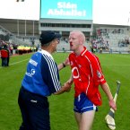 A blood-faced Mullane suffers the pain of defeat as manager Justin McCarthy consoles him.