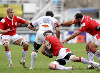 Castres' Pedrie Wannenburg is blocked by Ulster's Chris Henry, Robbie Diack and John Afoa.