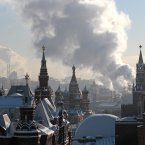 Steam from an electric power plant rises over Red Square with historical museum, left, St. Basil's cathedral, central, and Kremlin, right, in downtown Moscow, Russia, Wednesday, Jan. 23, 2013. After two weeks of snowfall Moscow enjoyed a cold sunny day. The Lenin Mausoleum, bottom center, is seen covered for reconstruction. (AP Photo/Mikhail Metzel)