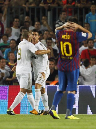 Leo Messi reacts to a Cristiano Ronaldo goal.