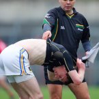 Players shed layers as they get used to the action. Here umpire Paul Hayes helps out Seamus Kennedy of Tipperary.
