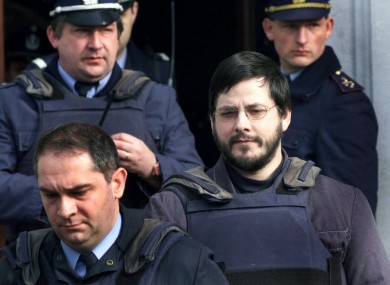 File photo from 2000 of Marc Dutroux (right) being led from a Belgian court.