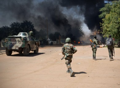 Malian soldiers, working with French forces, battle radical Islamic rebels in Gao, Mali yesterday.