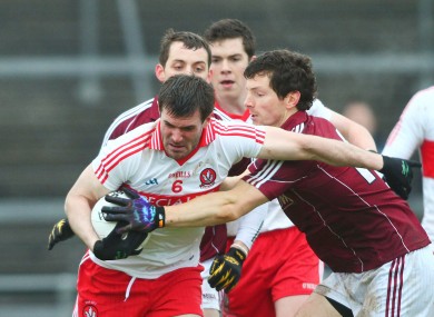 Galway's Micheal Meehan in action against Derry's Mark Lynch.