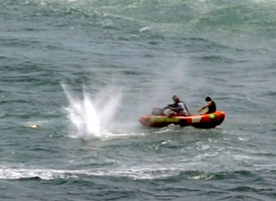 Police in inflatable rubber boats shoot at a shark off Muriwai Beach near Auckland, New Zealand, Wednesday, Feb. 27, 2013