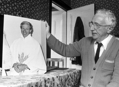 Fr Niall Molloy's brother Billy holds up a photo of his late brother, a year after Fr Niall was killed in 1985.