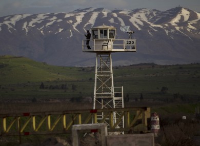 A UN peacekeeper from the UNDOF force stands guard on the border between Syria and Golan Heights last Friday.