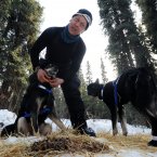 Four-time champion Martin Buser booties up his dog team.