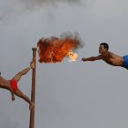 Indian army soldiers spit fire as they perform the mallakhamb, a traditional Indian gymnastic sport, during a display of skills at Officers Training Academy in Chennai, India. (AP Photo/Arun Sankar K.)