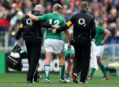A concussed Luke Marshall is helped from the field of play.